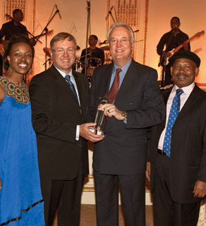 Dave Herbert, center, CEO of Great Safaris, accepting the 2010 Lifetime Achievement Ubuntu Award from the Hon M. van Schalkwyk, the South Africa Minister of Tourism.